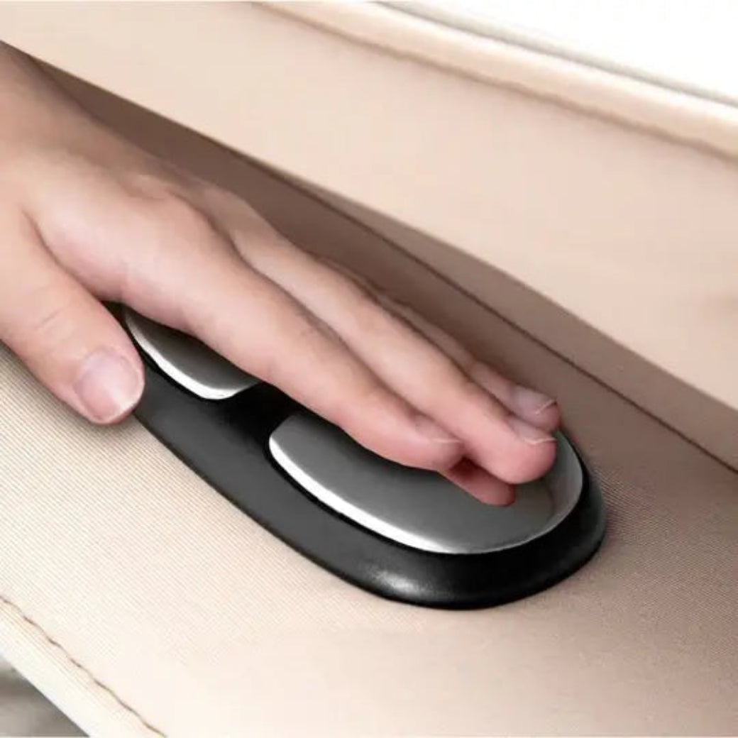 Hand pressing a black and silver handle on a vehicle door