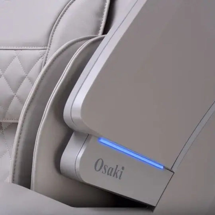 Close-up of a massage chair with Osaki branding and a blue light indicator.