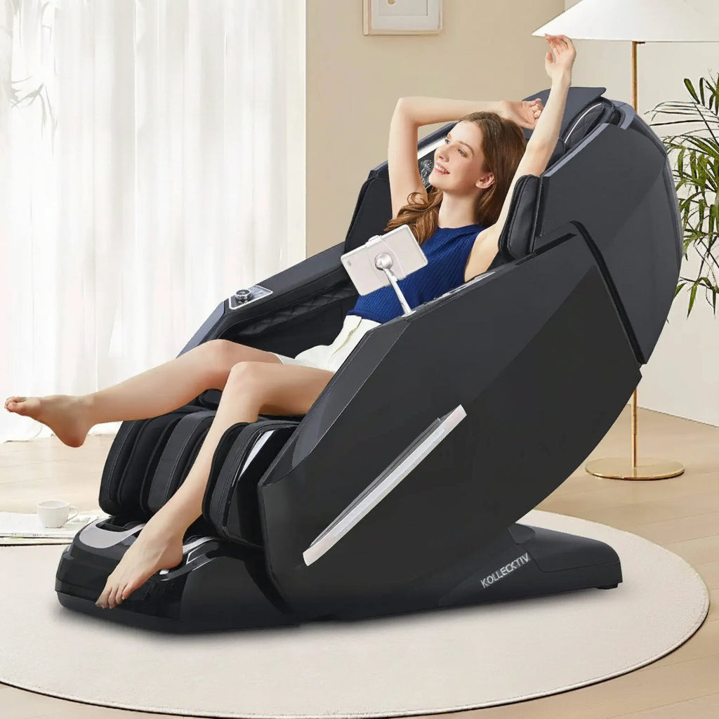 A woman reclines in a black modern massage chair in a bright indoor room.